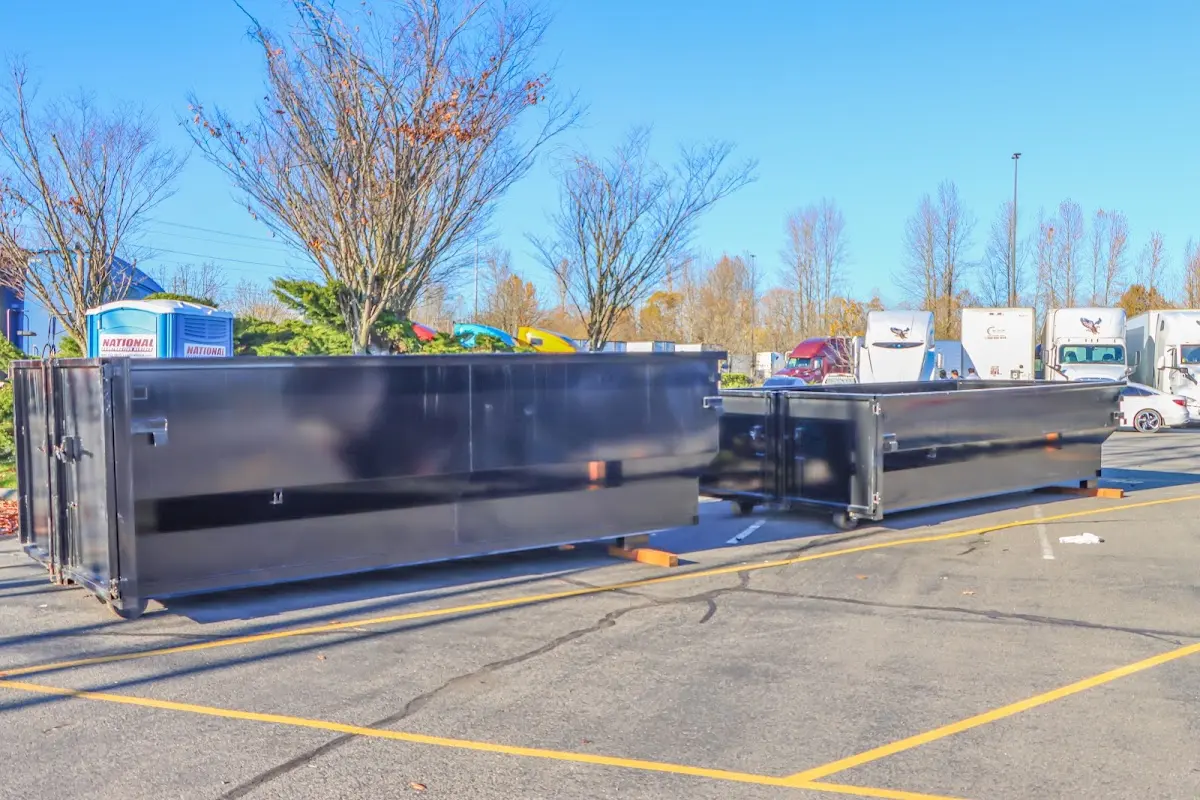 Professional dumpster rental service with roll-off container on residential driveway in Mount Vernon